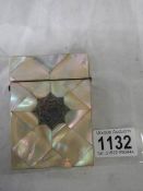 A mother of pearl card case in good condition.