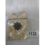 A mother of pearl card case in good condition.