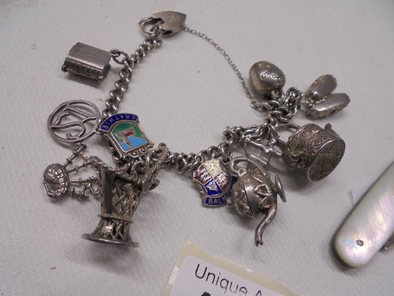 A silver bracelet with charms (42 grams) and a silver fruit knife. - Image 2 of 3