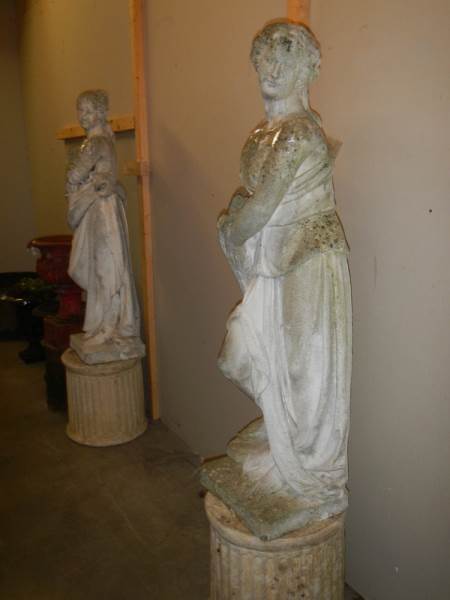 A pair of tall garden statues on plinths, COLLECT ONLY.
