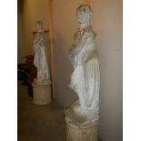 A pair of tall garden statues on plinths, COLLECT ONLY.