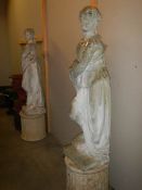 A pair of tall garden statues on plinths, COLLECT ONLY.