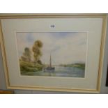 A framed and glazed watercolour river with boat signed Edward Emerson.
