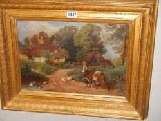 A gilt framed oil on canvas rural farming scene.
