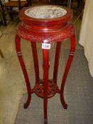 A mahogany marble top pot stand.