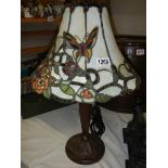 A table lamp with Tiffany style butterfly shade,.