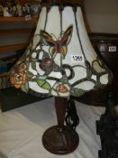 A table lamp with Tiffany style butterfly shade,.