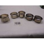 Five assorted silver napkin rings, 76 grams.