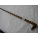 A fruitwood walking stick with carved dog head handle.