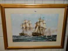 A framed and glazed print featuring sailing ships.