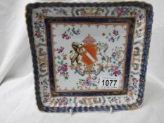 A 20th century hand painted armourial plate. Damaged in one corner.