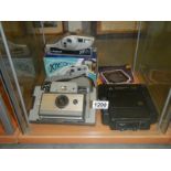 Two Polaroid and a Kodamatic 200 camera's.
