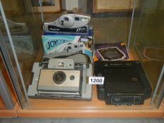 Two Polaroid and a Kodamatic 200 camera's.