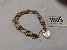 A 9ct gold gate bracelet with safety chain and padlock,