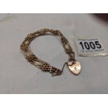 A 9ct gold gate bracelet with safety chain and padlock,