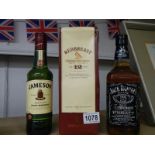 Three bottles of whisky - Redbrest, Jamesons and Jack Daniels.