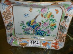 A hand painted Chinese bowl decorated with birds and fish.