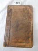 An early leather bound New Testament (damage to back of book),