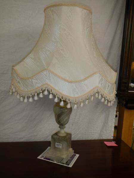 An alabaster table lamp with shade.