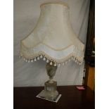 An alabaster table lamp with shade.