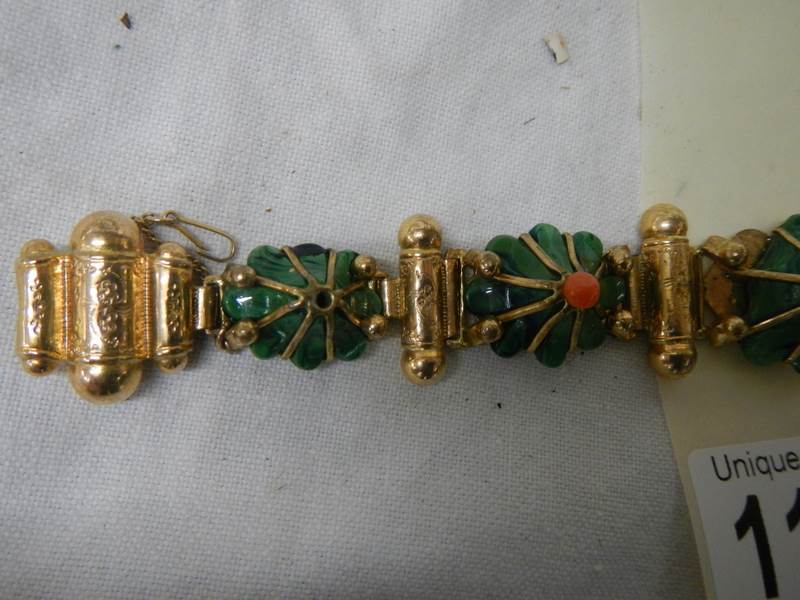 A yellow metal bracelet with flower shapes in green stone with red centre's - Image 2 of 5