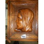 A carved wood bust of a lady.