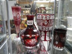 A quantity of red overlaid glass.