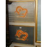 A pair of framed and glazed embroideries on silk of dragons.