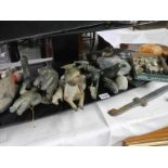 A shelf of assorted Inuit carvings etc.,