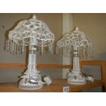 A pair of modern white table lamps with droppers.