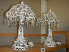 A pair of modern white table lamps with droppers.