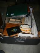 A large box of mixed postcards, stamps and albums etc.,