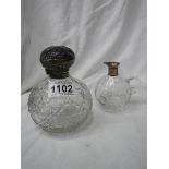 A silver topped perfume bottle and a glass jug with silver spout missing stopper.