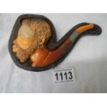 An old cased Meerscham pipe of a man's head.
