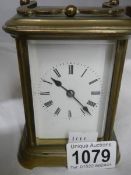 A brass carriage clock in working order.