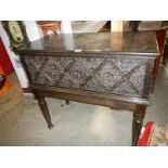 A carved oak chest on stand. COLLECT ONLY.
