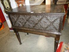 A carved oak chest on stand. COLLECT ONLY.