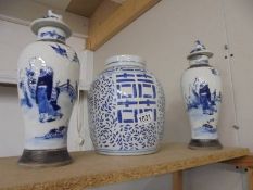A pair of Chinese blue and white lidded vases (a/f some signs of repair) & blue and white ginger jar