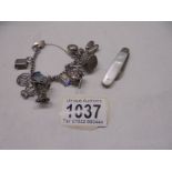 A silver bracelet with charms (42 grams) and a silver fruit knife.