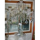 A glass five branch table centrepiece candle holder.