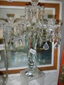 A glass five branch table centrepiece candle holder.