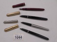 Three Parker fountain pens and one other.