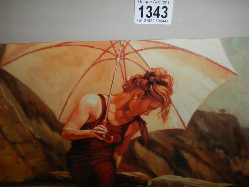 A framed and glazed beach scene featuring a lady with a parasol. - Image 3 of 3