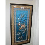 A framed and glazed embroidery on silk.