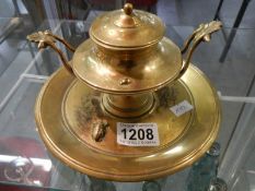 A Victorian brass inkwell.