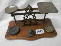 A set of early 20th century brass postal scales.