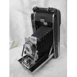 A vintage folding Polaroid camera.