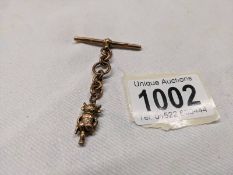 A 9ct gold Lincoln Imp charm on a 9ct gold 'T' bar. 6.4 grams.