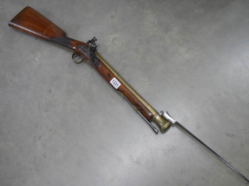 An antique brass barrelled swivel bayonet blunderbuss, 79cm long.