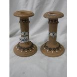 A pair of good Doulton Lambeth candlesticks.